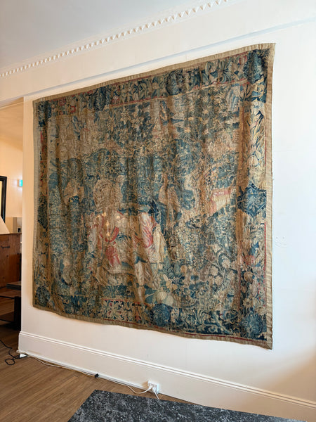 A Flemish verdure tapestry with figures and exotic bird probably by Oudenaarde