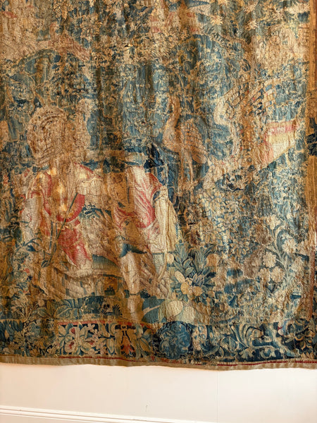 A Flemish verdure tapestry with figures and exotic bird probably by Oudenaarde
