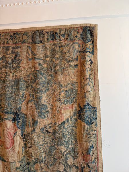 A Flemish verdure tapestry with figures and exotic bird probably by Oudenaarde