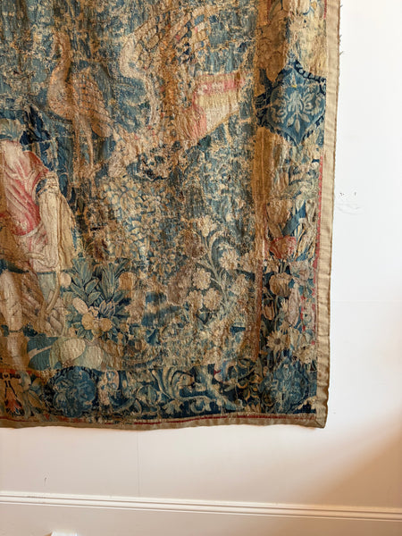 A Flemish verdure tapestry with figures and exotic bird probably by Oudenaarde