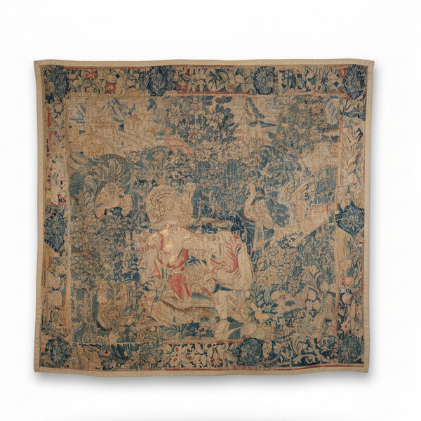 A Flemish verdure tapestry with figures and exotic bird probably by Oudenaarde