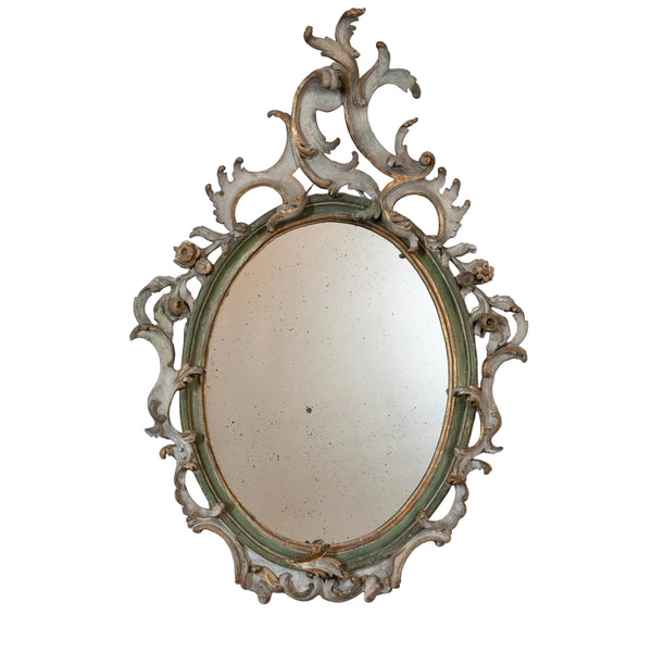 An Italian Rococo Carved, Painted and Parcel-Gilt Oval Mirror