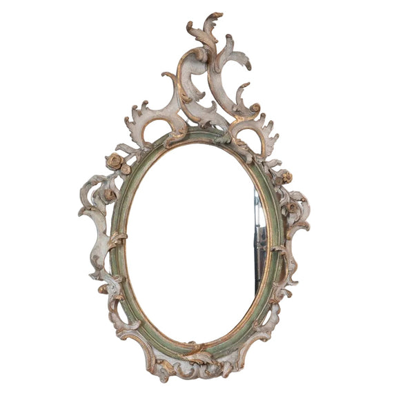 An Italian Rococo Carved, Painted and Parcel-Gilt Oval Mirror