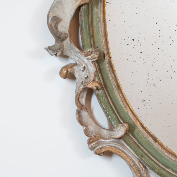 An Italian Rococo Carved, Painted and Parcel-Gilt Oval Mirror