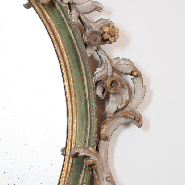 An Italian Rococo Carved, Painted and Parcel-Gilt Oval Mirror