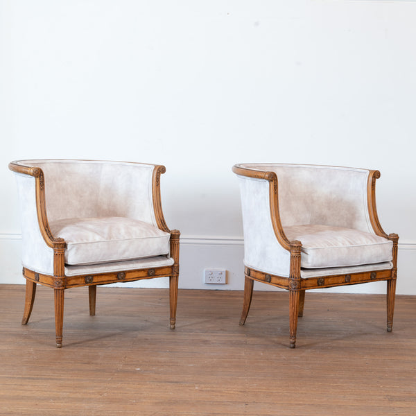 A Pair of French Directoire Style Carved Beechwood Bergères en Gondole, Late 19th / Early 20th Century