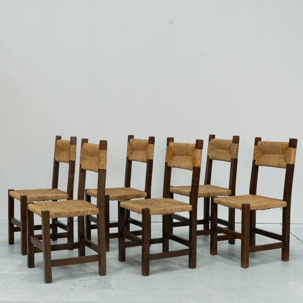 A set of Six rush and beech dining chairs, in the manner of Charlotte Perriand.