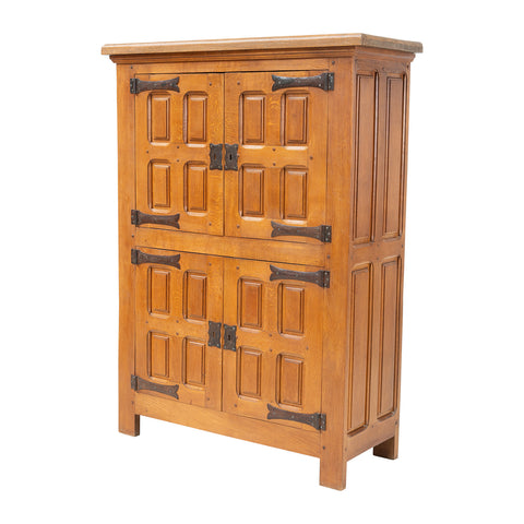 Wooden cabinet with panel design and metal handles on a white background
