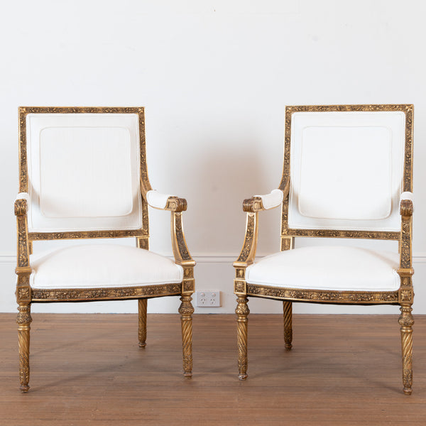 A pair of French Louis XVI style giltwood Fauteuils
