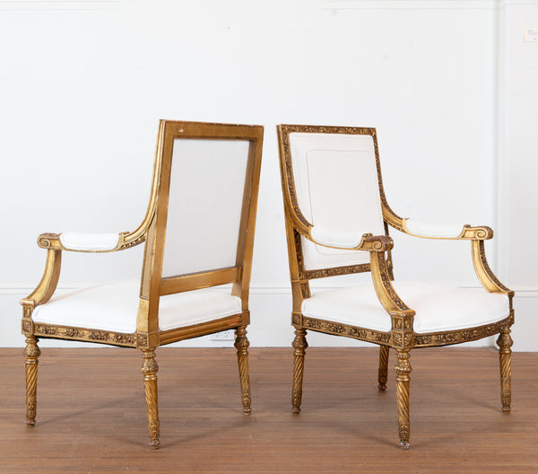 A pair of French Louis XVI style giltwood Fauteuils