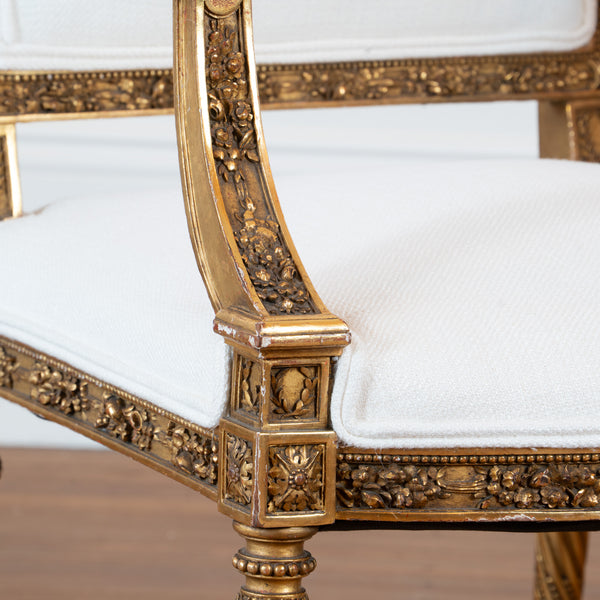 A pair of French Louis XVI style giltwood Fauteuils