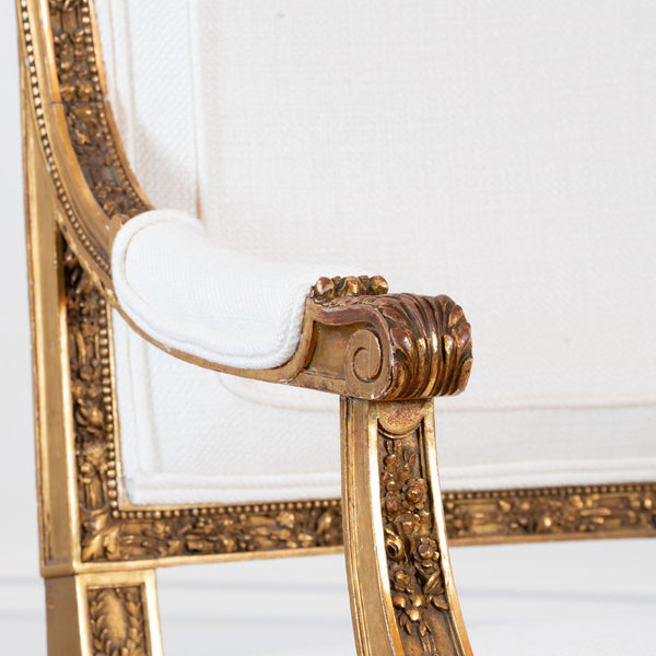 A pair of French Louis XVI style giltwood Fauteuils