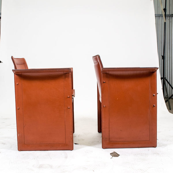 A pair of leather Korium chairs by Tito Agnoli