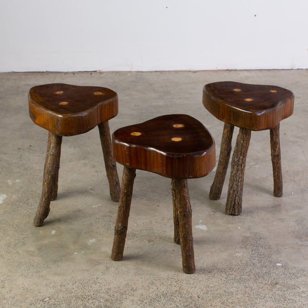 A Set of Three Brutalist stools raised on three naturalistic legs