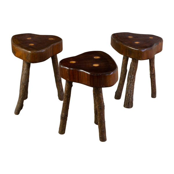 A Set of Three Brutalist stools raised on three naturalistic legs