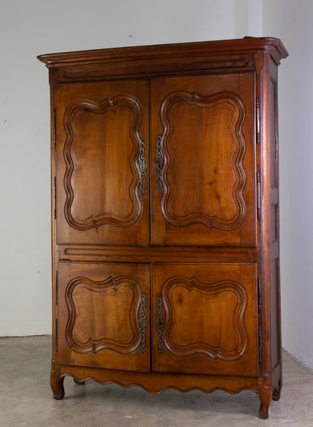 A Provincial Louis XV Armoire in Panelled cherrywood