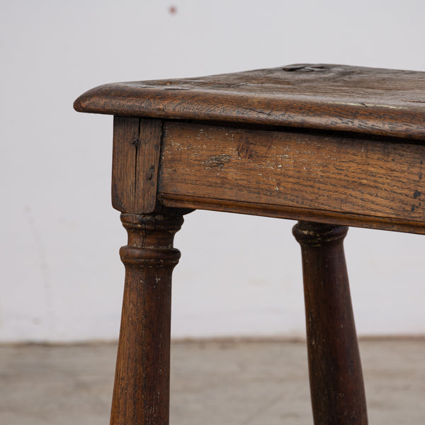 AN ANTIQUE ENGLISH OAK STOOL WITH PEG JOINT CONSTRUCTION