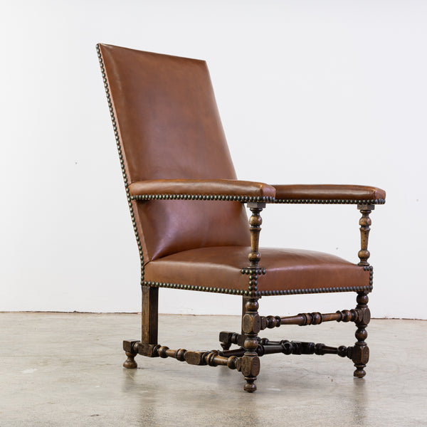 Combination of two armchairs with a high, slightly tilted back, one inangle, the other in molded or turned walnut; armrests